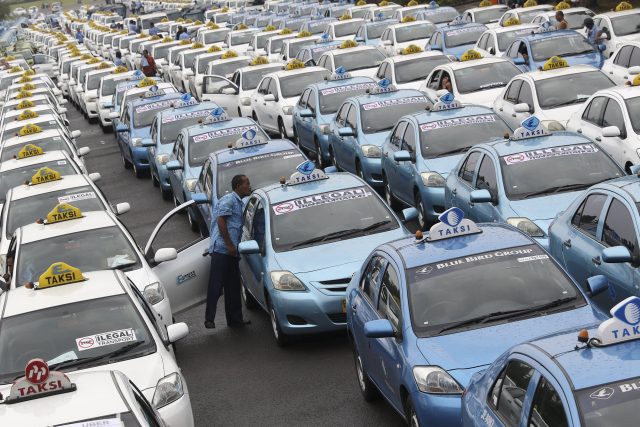Ratusan taksi diparkir di Silang Monas saat unjuk rasa menolak transportasi berbasis online di Jalan Medan Merdeka Selatan, Jakarta, Senin (14/3)